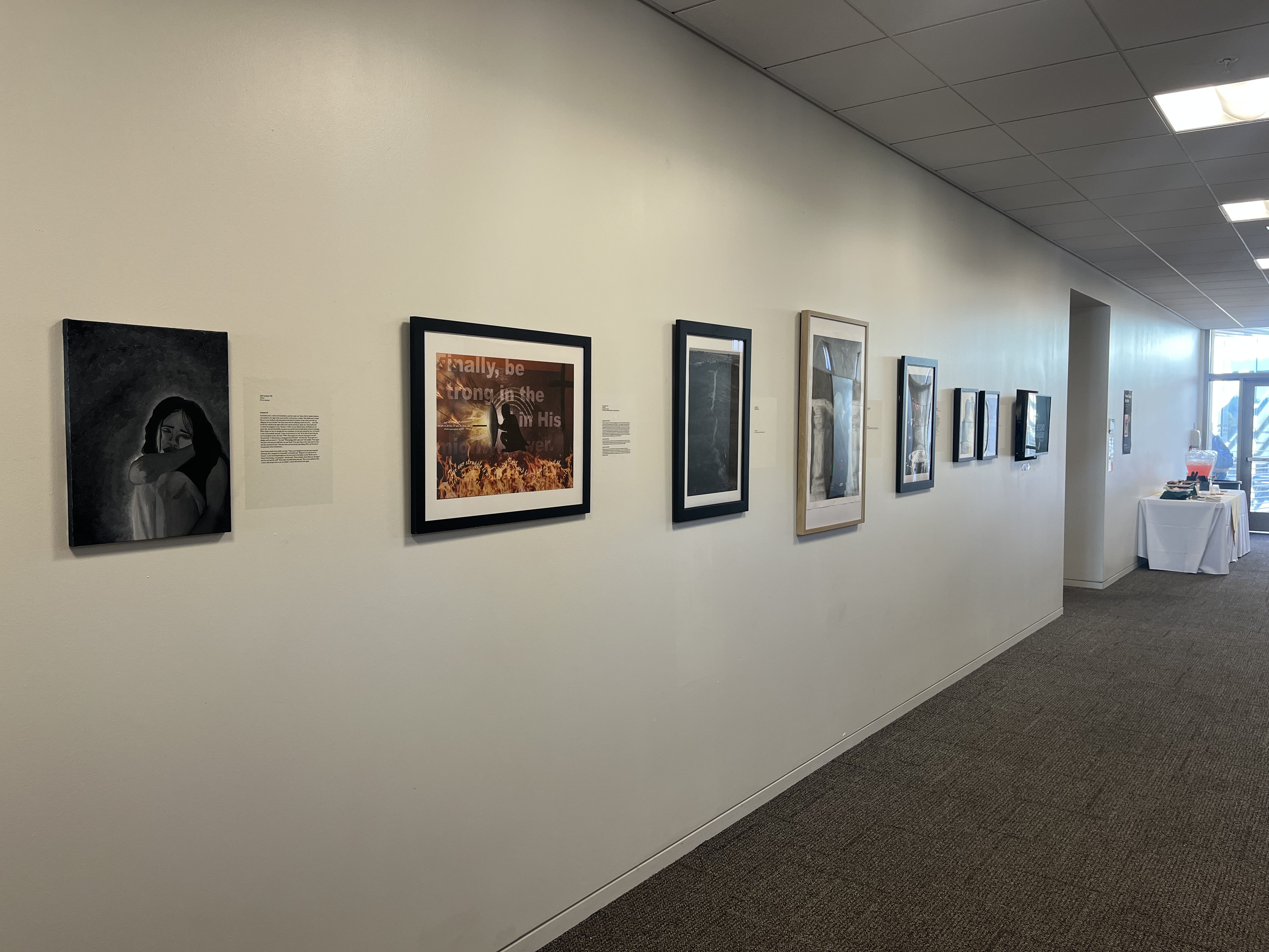 One wall of the Grimm Hall hallway and its artwork.